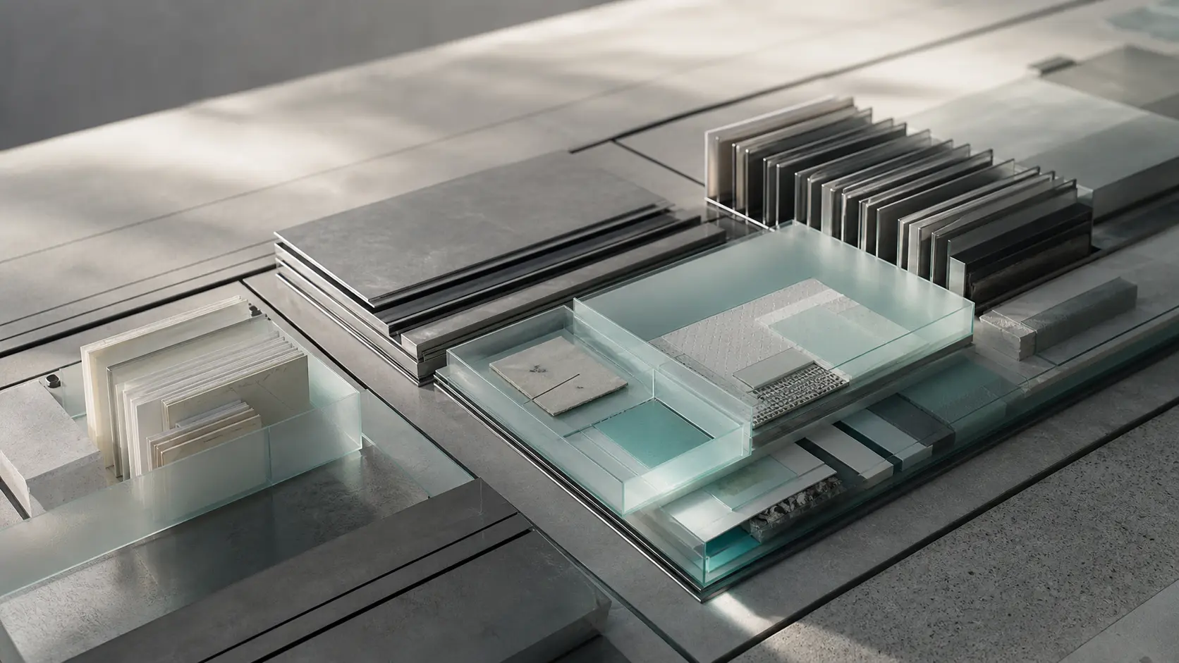 Abstract editorial arrangement of layered archival trays, metal, and frosted glass